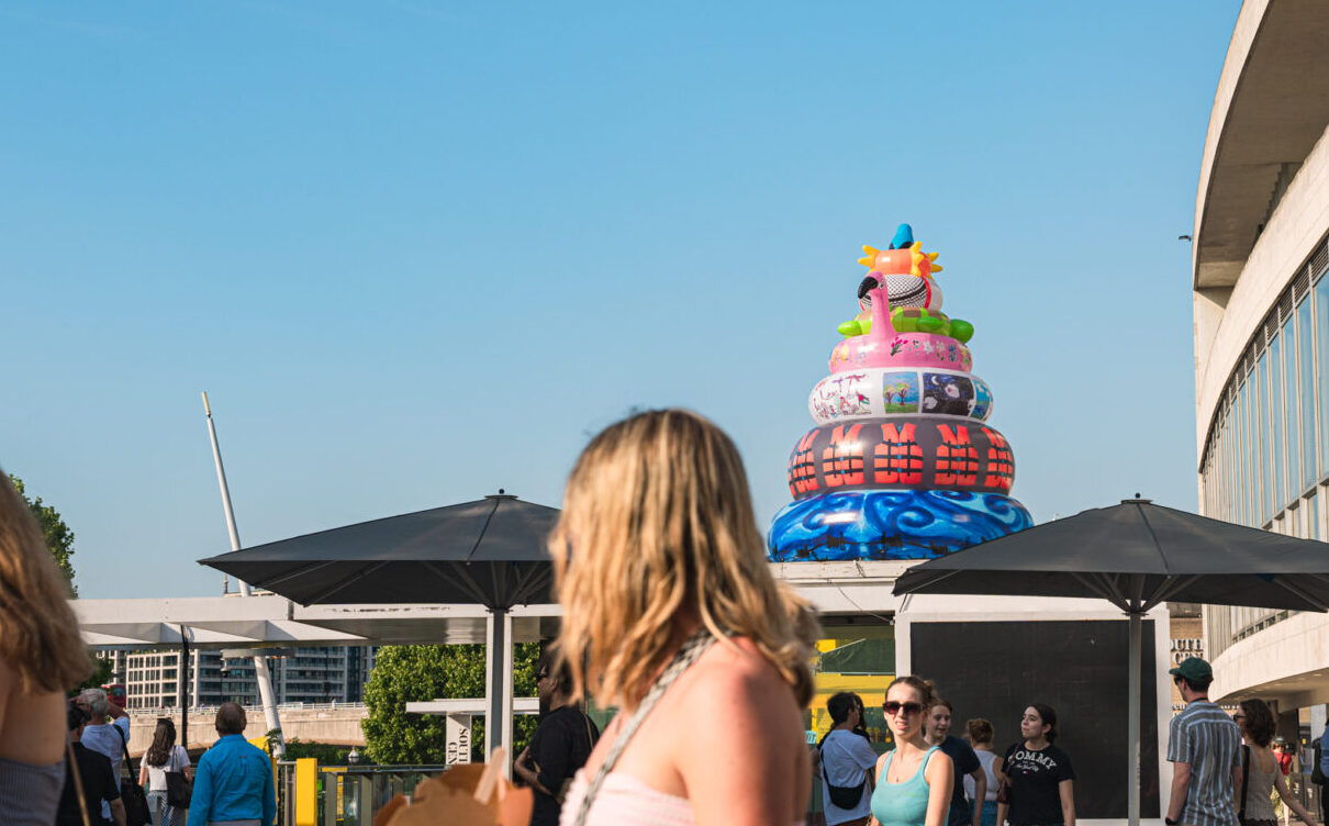 large inflatable sculpture of rubber rings featuring images by palestinian children and a sun bird on top